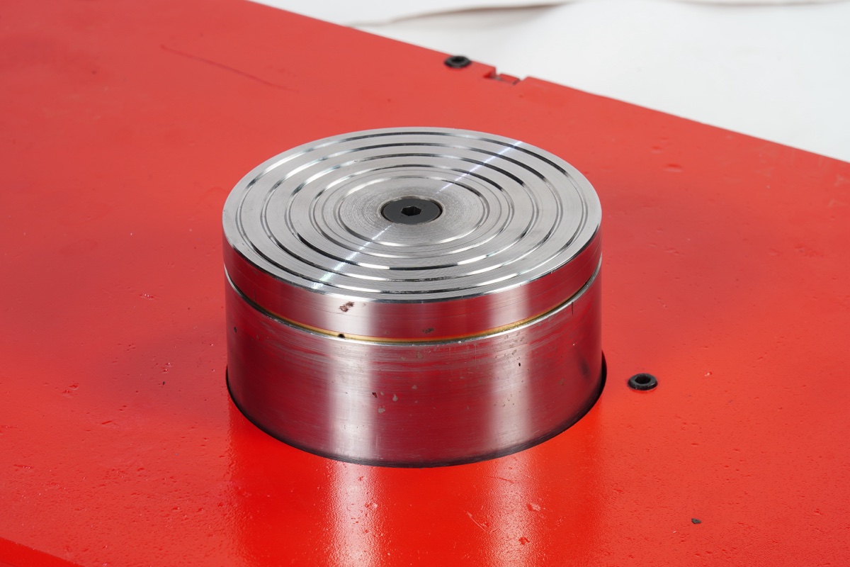Silver load-bearing turntable pad close-up showing precision spiral surface