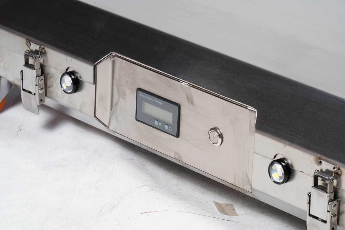 Stainless steel control panel close-up showing digital display, indicator LEDs, power button and side handles